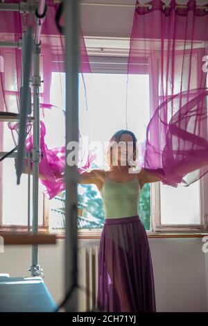 Woman Exercising on Pilates Machine with Transparent Skirt. Stock Photo