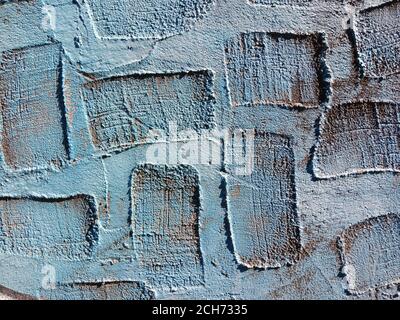 Blue real texture of plaster background with areas of rectangular depressions, which can be used to overlay text or drawings. Stock Photo