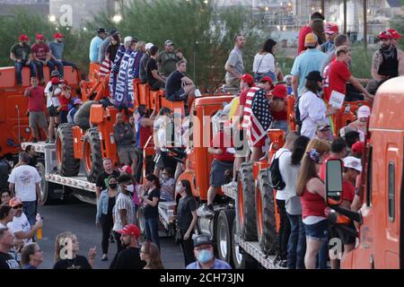 Henderson, NV, USA. 13th Sep, 2020. Supporters of President Donald Trump gather outside Xtreme Manufacturing to watch him on a big screen as he gives a speech. The venue was filled to capacity and much of the crowd had overflowed outside onto the street. Credit: Young G. Kim/Alamy Live News