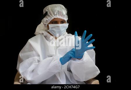 Doctor wearing  face surgical mask and gloves  fighting against corona virus outbreak Stock Photo