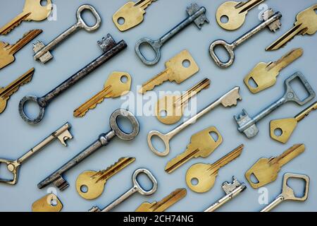 Metal keys on the grey background. Symbol for answering questions and solving a problem. Stock Photo