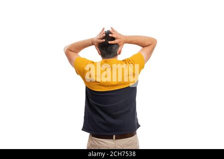 Adult model man making desperate gesture touching head using both hands with back to camera wearing black and yellow tshirt summer clothing isolated o Stock Photo