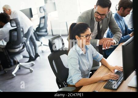 Programmers cooperating at IT company developing apps Stock Photo