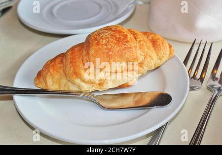 Baked croissant on a white plate Stock Photo