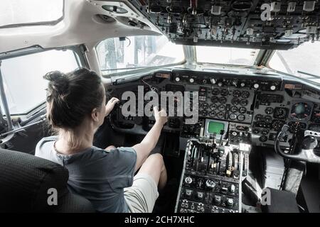 Woman in cockpit of airplane in science museum. Stock Photo