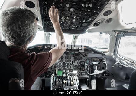 Man in cockpit of airplane in science museum. Stock Photo
