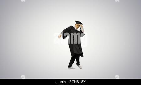 Male graduate in robe and mortarboard doing modern dance looking Stock Photo