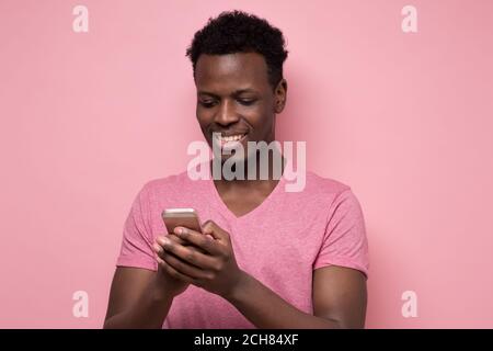Young african man reading sms on the phone Stock Photo