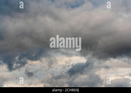 Stunning thunderclouds in dusk sky, rainy and overcast weather. Scenery cloudscape and meteorology background. Motion blur, soft focus Stock Photo