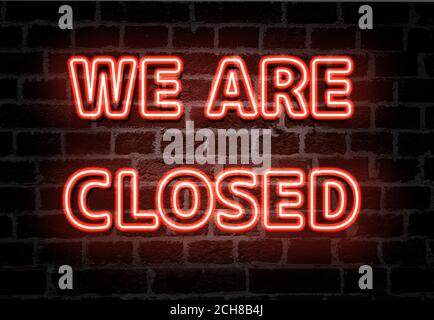 We are closed red neon light entrance sign on brick wall Stock Photo