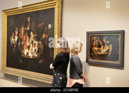 Members of staff at Tate Britain during a photo call for the only known sketch (right) of painting An Experiment on a Bird in an Air Pump 1768 (left) by British artist Joseph Wright of Derby (1734-1797). Stock Photo