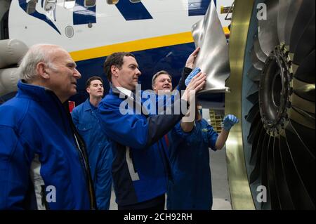 Chancellor of the Exchequer George Osborne (centre) is joined by former adversaries Ed Balls (right) and Sir Vince Cable (left) as they view maintenance work, in the Ryanair hangar at Stansted Airport, where the Chancellor said that 450 jobs and almost &Acirc;£1 billion in investment announced by Ryanair would be 'at risk if we left the EU'. Stock Photo