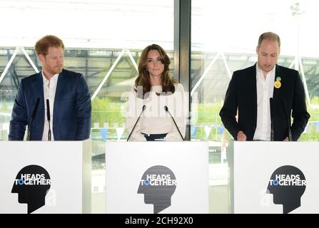 (left to right) Prince Harry, the Duchess and the Duke of Cambridge speak at the Queen Elizabeth Olympic Park in east London where they are launching Heads Together - their new campaign to end mental health stigma. Stock Photo