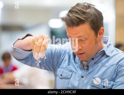 Jamie Oliver makes bread with pupils at Kings Cross Academy in London, during a visit on Food Revolution Day, part of the Food Revolution campaign which aims to tackle issues of child nutrition. Stock Photo