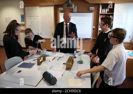 Deputy First Minister and new Education Secretary John Swinney during a visit to his former school, Forrester High School in Edinburgh, where he joined pupils (left to right) Ellie Owens, Abigail Cameron, Ryan Anderson and Ellie Feeney for a science class as they carried out DNA extraction in kiwi fruit. Stock Photo