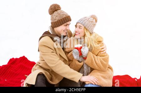 Winter Portrait Of Young Couple Having Romantic Date Outdoors Stock Photo