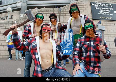 Rugby fans dressed as lumberjacks pose outside the stadium the Dacia Magic Weekend match at St James' Park, Newcastle. Stock Photo