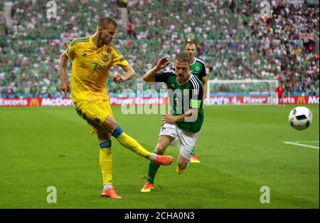 Ukraine's Andriy Yarmolenko (left) and Northern Ireland's Steven Davis in action. Stock Photo