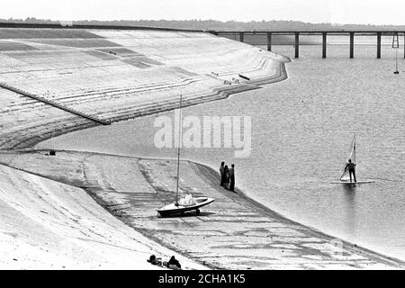 The shore is creeping closer to yachtsman who use the new Queen Mother Reservoir at Datchet, for the drought and London's demand for water are bringing down the water level. The reservoir, covering 475 acres, can hold 8,300 million gallons of water. Stock Photo