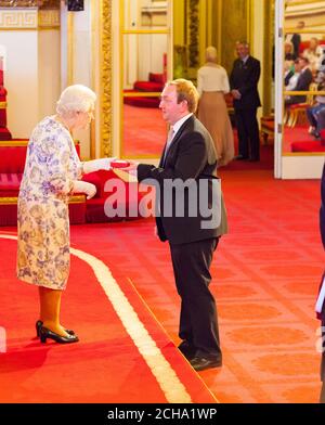Mr. Adam Bradford from the UK receives a medal from Queen Elizabeth II during the Queen's Young Leaders Awards 2016 at Buckingham Palace, London. PRESS ASSOCIATION Photo. Picture date: Thursday June 23, 2016. Photo credit should read: Dominic Lipinski/PA Wire Stock Photo