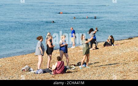 Brighton UK 14th September 2020 - Time for a selfie for these swimmers on Brighton beach before taking a cooling dip in the sea as temperatures are forecast to reach 30 degrees in parts of the South East  : Credit Simon Dack / Alamy Live News Stock Photo