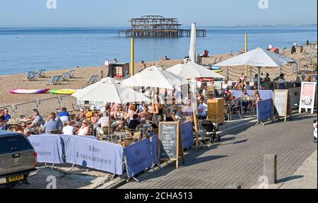 Brighton UK 14th September 2020 - Brighton seafront bars and cafes are already busy in the morning as visitors enjoy the hot sunny weather as temperatures are forecast to reach 30 degrees in parts of the South East  : Credit Simon Dack / Alamy Live News Stock Photo