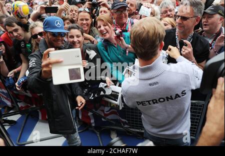 Mercedes Lewis Hamilton and Nico Rosberg during Paddock Day of the 2016 British Grand Prix at Silverstone Circuit, Towcester. Stock Photo