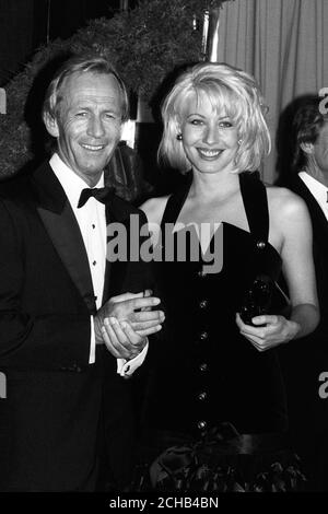 Australian actor Paul Hogan and Linda Kozlowski, his co-star in 'Crocodile' Dundee II. They were attending the charity premiere of the film at the Empire, Leicester Square, London. Stock Photo