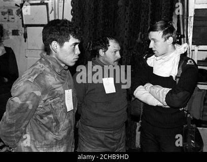 A Royal Navy interpreter talking to two Argentinian prisoners on one of the British task force ships in San Carlos Water. Stock Photo
