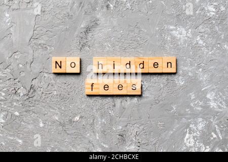 No hidden fees word written on wood block. No hidden fees text on cement table for your desing, Top view concept. Stock Photo