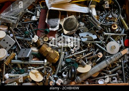 old box ful of metal nails screws and other Stock Photo