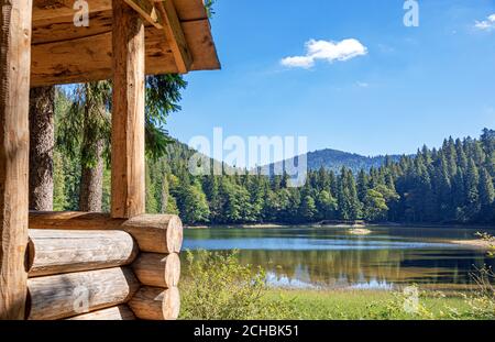 Wooden house on the shore of a picturesque lake. Stock Photo