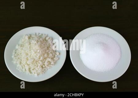 Sea Salt and Table Salt Isolated on Black Background Stock Photo