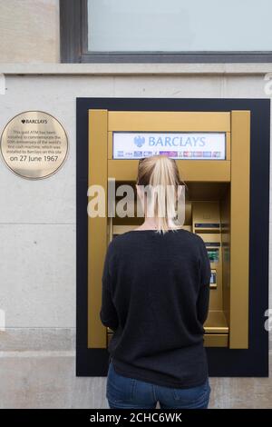 EMBARGOED TO 0001 TUESDAY JUNE 27 EDITORIAL USE ONLY Barclays unveils a gold ATM at its Enfield branch in London to commemorate the 50th anniversary of the world&Otilde;s first cash machine, installed by the bank at the same site on 27th June 1967.  Stock Photo