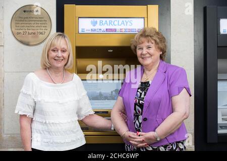 Former Barclays employees Carol Greygoose, aged 68, and Judyth Simson, aged 70, attend the unveiling of a gold ATM at its Enfield branch in London to commemorate the 50th anniversary of the world's first cash machine, installed by the bank at the same site on 27th June 1967. Stock Photo