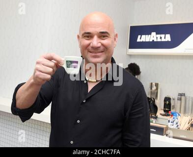 EDITORIAL USE ONLY Former Wimbledon champion and Lavazza Global Ambassador Andre Agassi hands out coffee to tennis fans at The All England Lawn Tennis and Croquet Club in Wimbledon to celebrate Lavazza's 7th year as the Official Coffee of The Championships. Stock Photo