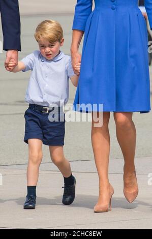 Prince George holds hands with the Duke and Duchess of Cambridge as they depart from Chopin airport, in Warsaw, on day three of their five-day tour of Poland and Germany. PRESS ASSOCIATION Photo. Picture date: Wednesday July 19, 2017. See PA story ROYAL Cambridge. Photo credit should read: Dominic Lipinski/PA Wire Stock Photo