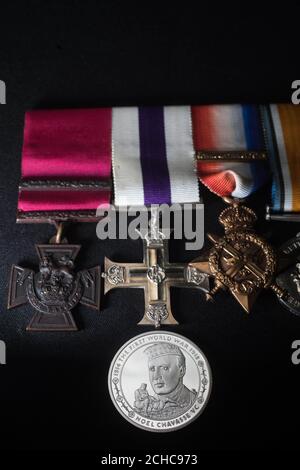 EDITORIAL USE ONLY A commemorative &pound;5 coin, which honours First World War hero Captain Noel Chavasse, unveiled by The Royal Mint at the Imperial War Museum in London, alongside his Victoria Cross that is part of the Lord Ashcroft collection.  Stock Photo