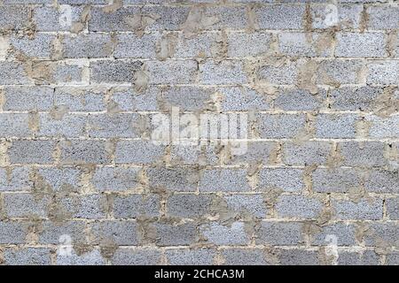 Monochrome texture of a wall made of concrete blocks connected cement. Abstract background for design. Stock Photo