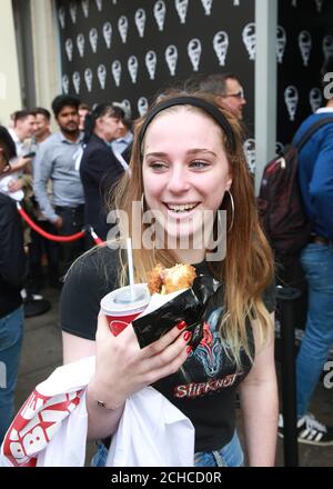 Customer Imogen Dunning from London tries the 'Double Down', which is a bun-less burger that features two Original Recipe chicken fillets, and will be on sale in the UK for 6 weeks only from October 9th, outside a branch of KFC in Gloucester Road in London Stock Photo