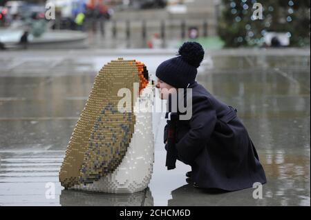 EDITORIAL USE ONLY Harry Rudden-Vine, aged four, with a Porg, the latest characters to join the Star Wars universe, appear in Trafalgar Square to launch the latest LEGO product range ahead of Christmas.  Stock Photo