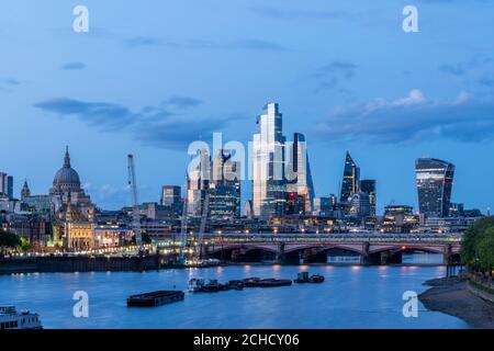 Shot during Covid 19 lockdown, view at twilight to the City looking east from Waterloo Bridge. Blackfriars Bridge runs across bottom of frame. From le Stock Photo