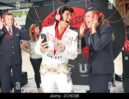 EDITORIAL USE ONLY An Elvis impersonator with British Airways Cabin Crew member Rebecca Sullivan, at the launch of the 'Sights and Sounds of Tennessee' experience, hosted by the Tennessee Department of Tourist Development at Waterloo Station London. Stock Photo