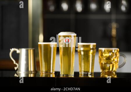 EDITORIAL USE ONLY The traditional pint glass has been redesigned by iconic British designer Sir Kenneth Grange, who celebrates his 89th birthday on July 17th, for Camden Town Brewery&Otilde;s Hells lager, London.  Stock Photo