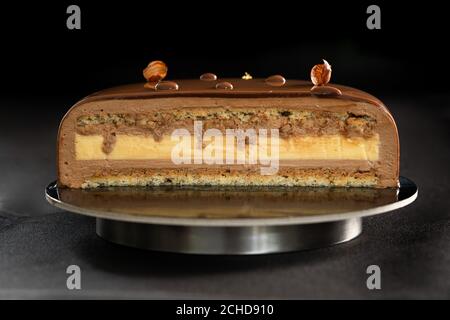 Half or slice of chocolate mousse cake isolated on black background. Copy space. High quality photo.  Stock Photo
