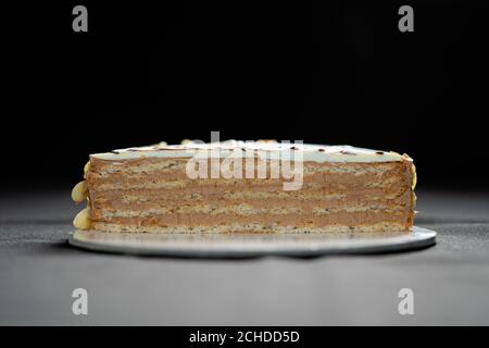 Half or slice of chocolate mousse cake isolated on black background. Copy space. High quality photo.  Stock Photo