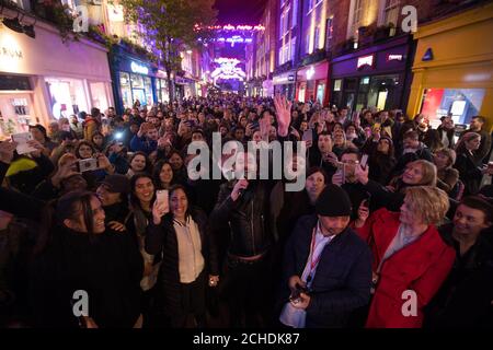 EDITORIAL USE ONLY Bulsara and His Queenies, Official Queen tribute band perform on stage below the Bohemian Rhapsody lights as Christmas launches on Carnaby Street, London.  Stock Photo