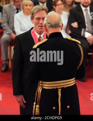 Hugh Laurie is made a CBE (Commander of the Order of the British Empire) by the Prince of Wales during an Investiture ceremony at Buckingham palace, London. Stock Photo