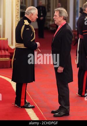 Hugh Laurie is made a CBE (Commander of the Order of the British Empire) by the Prince of Wales during an Investiture ceremony at Buckingham palace, London. Stock Photo