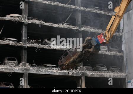 Burnt out cars are removed from their parking spaces as work began on Wednesday to demolish the multi-storey Liverpool Waterfront Car Park near to the Echo Arena which was destroyed by fire on New Year's Eve 2017. Stock Photo